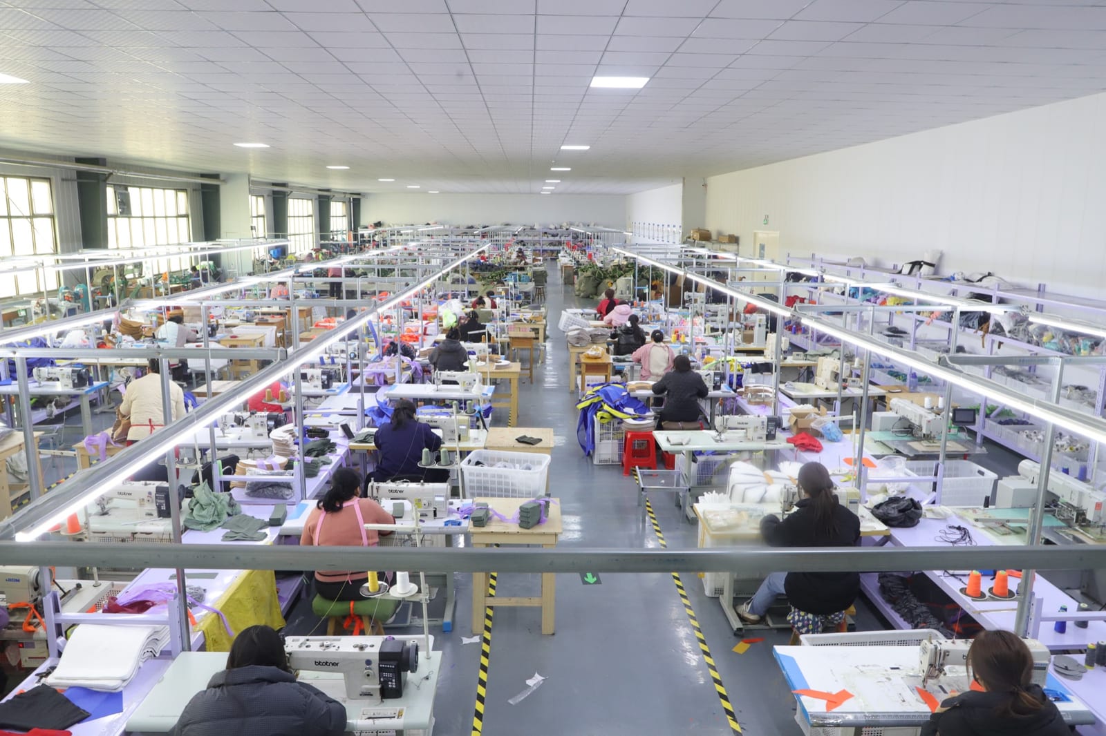 Sewing workshop with workers assembling bags at Sanjin factory